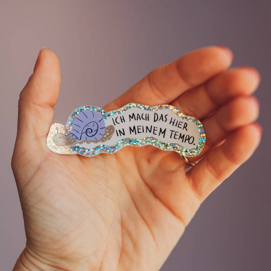 Glitzersticker 'Ich mach das hier in meinem Tempo' von Liesel's Wicht mit Schnecken-Motiv, in der Hand gehalten – für Brotdose und Trinkflasche