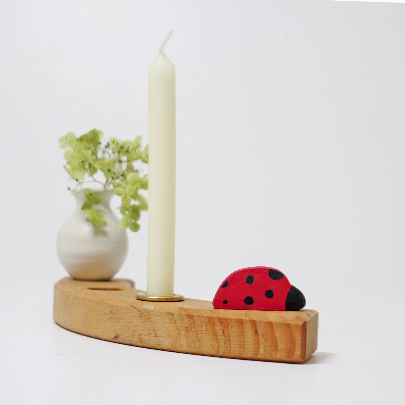Marienkäfer-Stecker aus Holz von Grimms für Geburtstagsring und Jahreszeitenring im natürlichen Lifestyle-Look mit Kerze und Blumenvase bei Burgfrollein