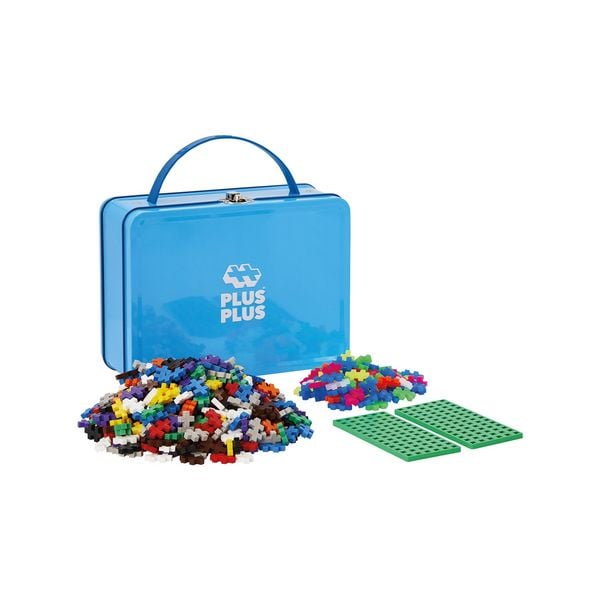 Plus-Plus 600 Kreativbausteine in Bunt mit geschlossener blauer Metallbox mit Plus-Plus-Logo, zwei Haufen bunter Bausteine und zwei grünen Bauplatten