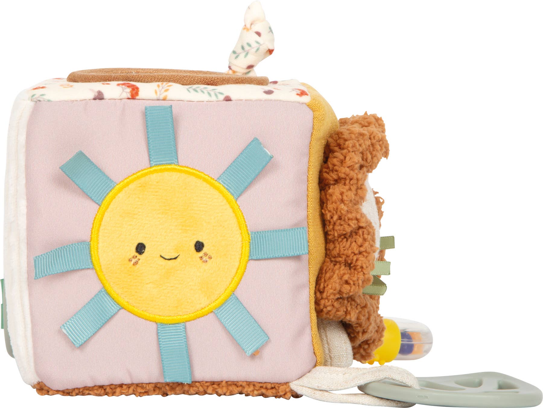 Spielwürfel „Little Lion" von Small Foot mit lächelndem Sonnenmotiv auf rosa Seite, blauen Stoffschlaufen und seitlich angebrachtem Silikon-Beißring – Babyspielzeug zur Förderung der Sinne ab 0 Monaten