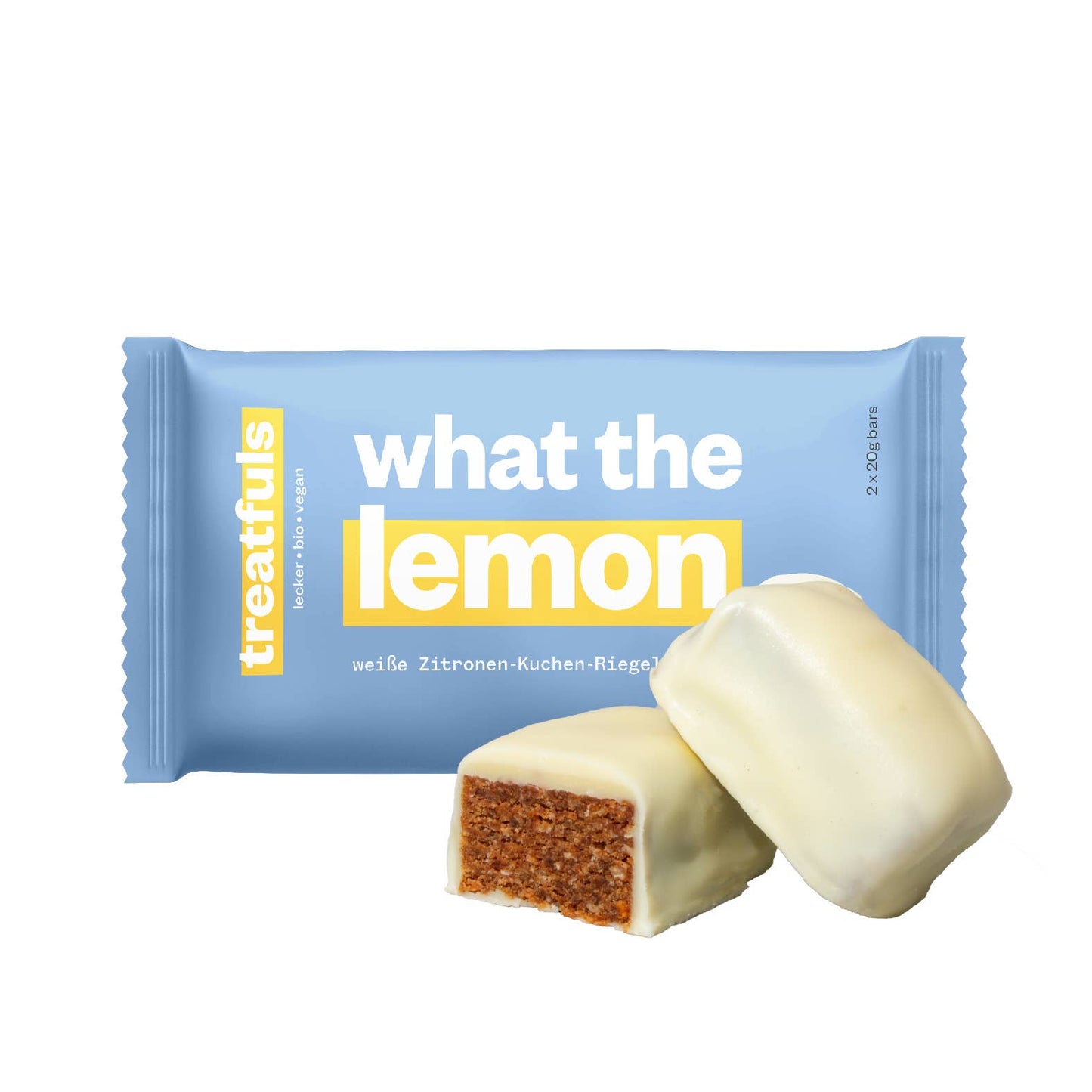 Treatfuls Zitronen-Kuchen-Riegel „What The Lemon“ mit angeschnittenem Riegel in weisser Schokolade – Bio, vegan, glutenfrei und ohne raffinierten Zucker